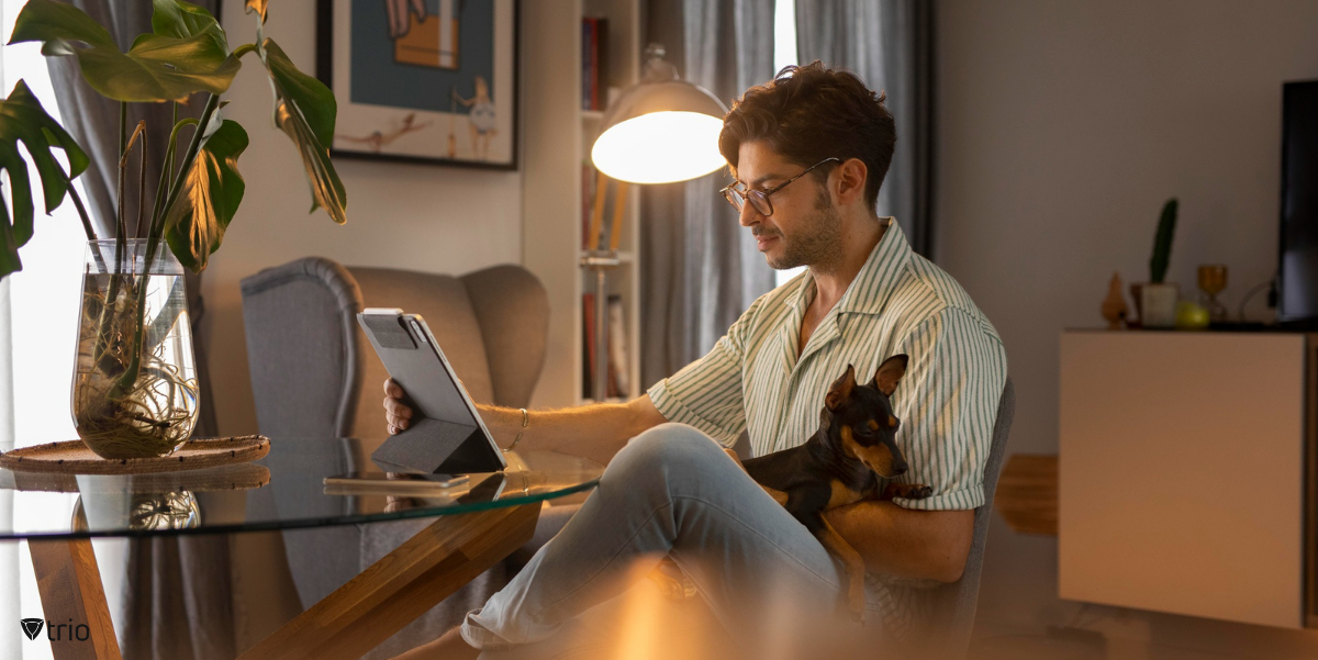 Employee working from home with his dog on his lap