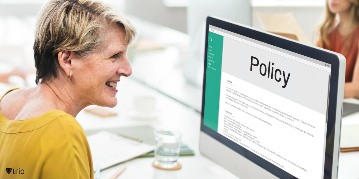 A person looking at a computer monitor displaying the words "Policy."