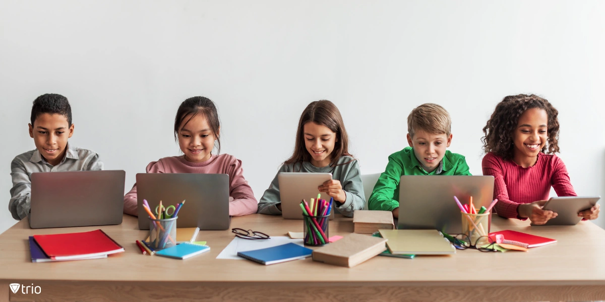 Teacher helping students use digital tools in the classroom