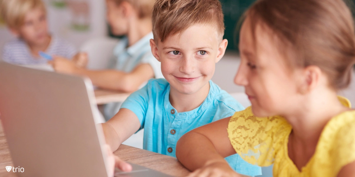 Boy and girl working with laptop using unfiltered school internet