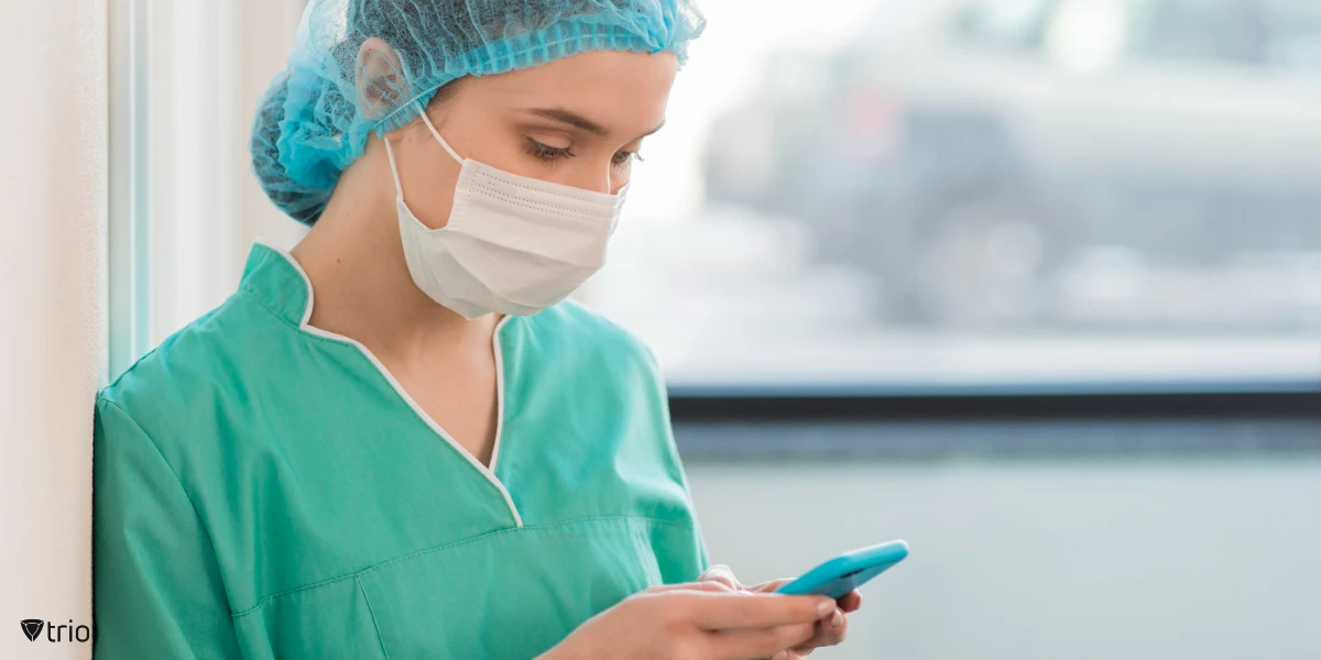 doctor in uniform holding a phone