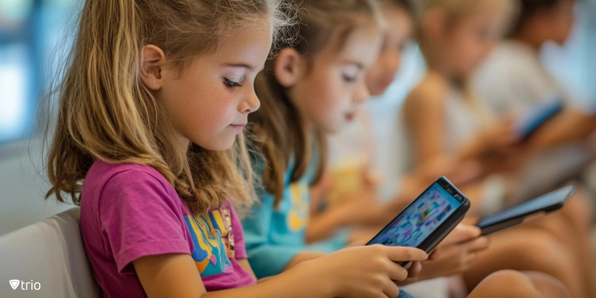 Small children using smartphones in a school