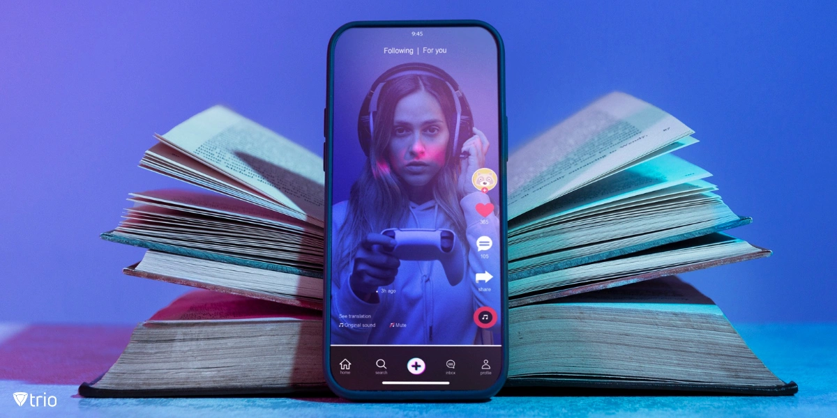 Phone showing video of child with a controller on a social media platform balanced against a book