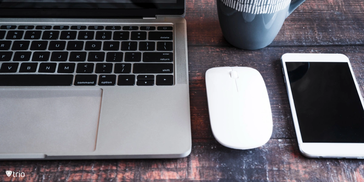 Apple devices on desk with a mug