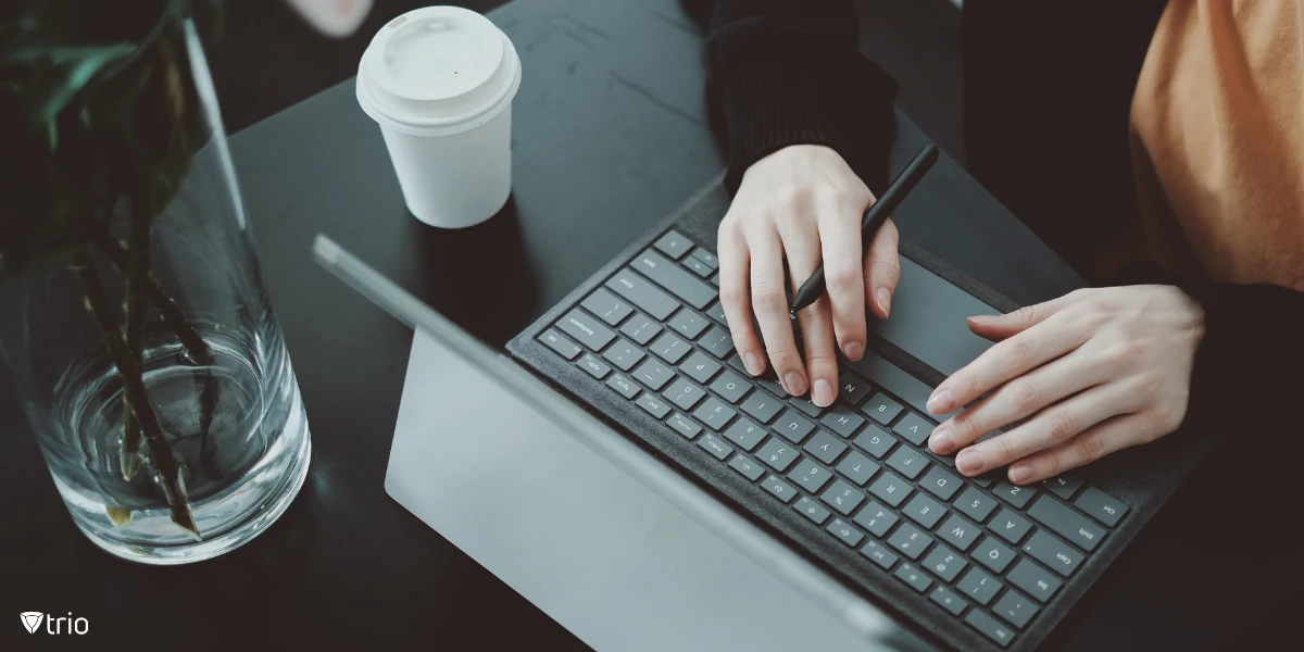 Person working on a laptop at a desk.