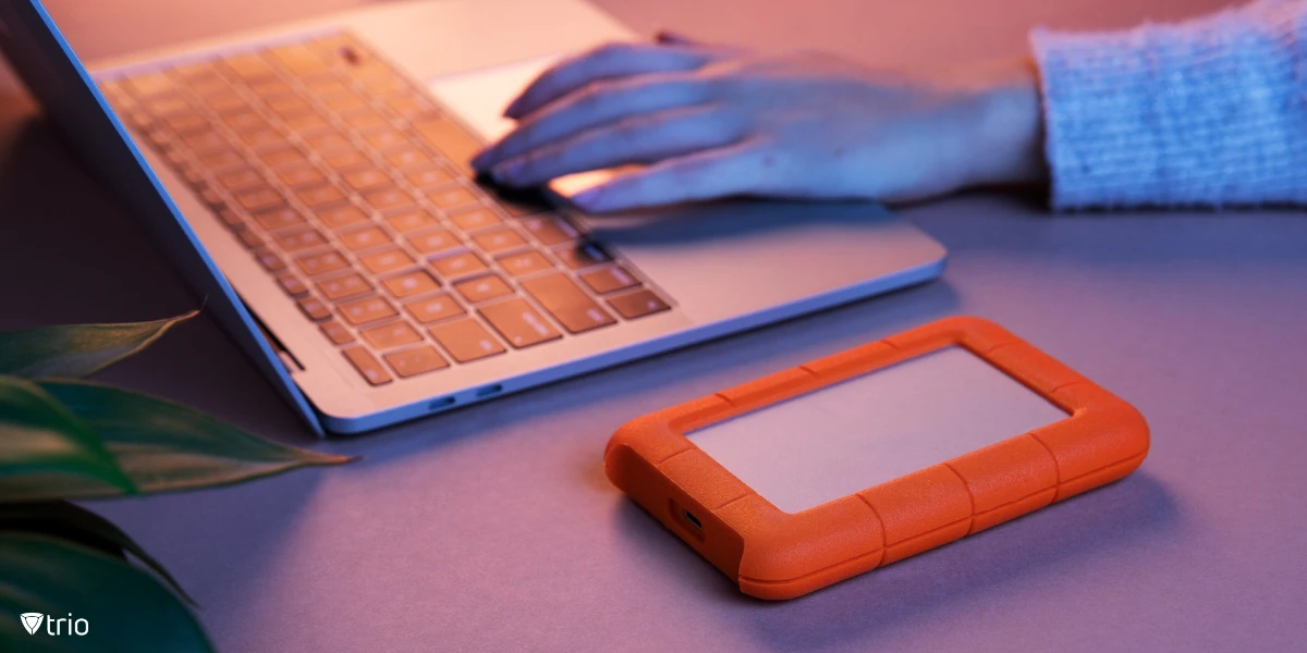 An external hard drive beside a laptop