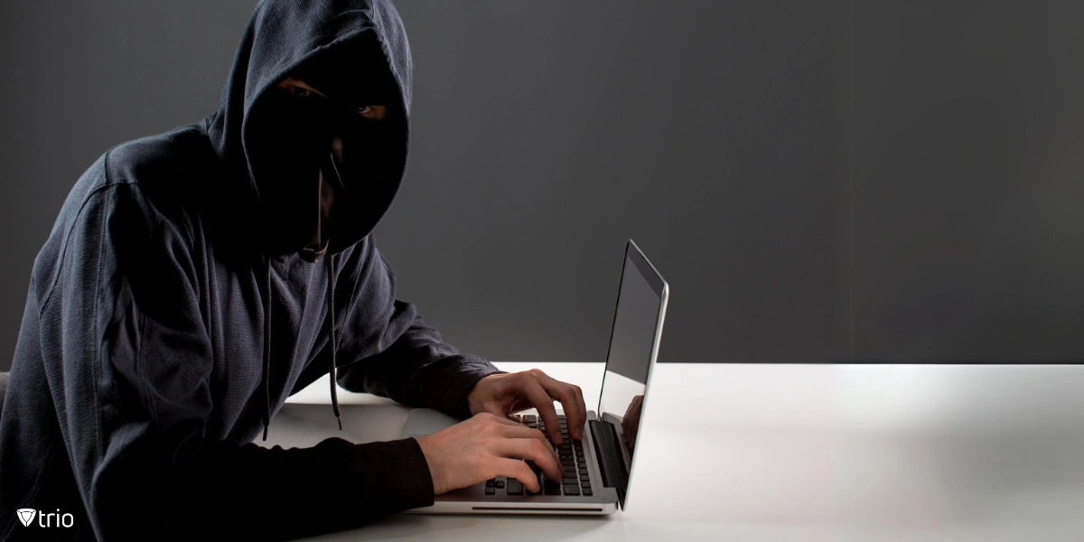 Side view of male hacker with laptop