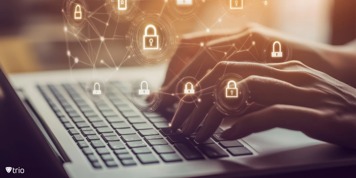 Closeup of hands typing on a laptop keyboard with floating lock icons representing digital security