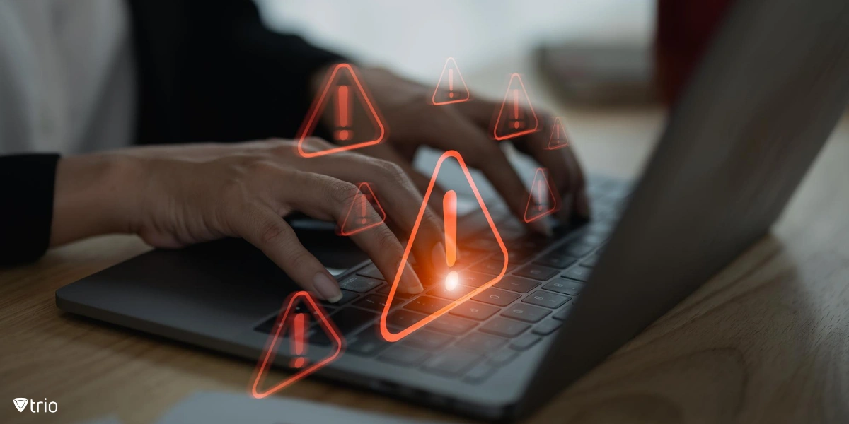 hands of a businesswoman using a laptop keyboard with visual of multiple red triangular warning signs with exclamation marks