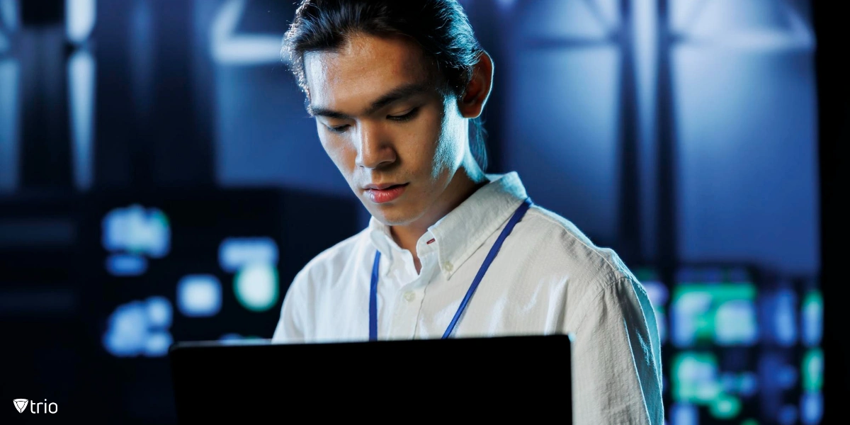 A young professional working on a laptop in a technology-focused environment