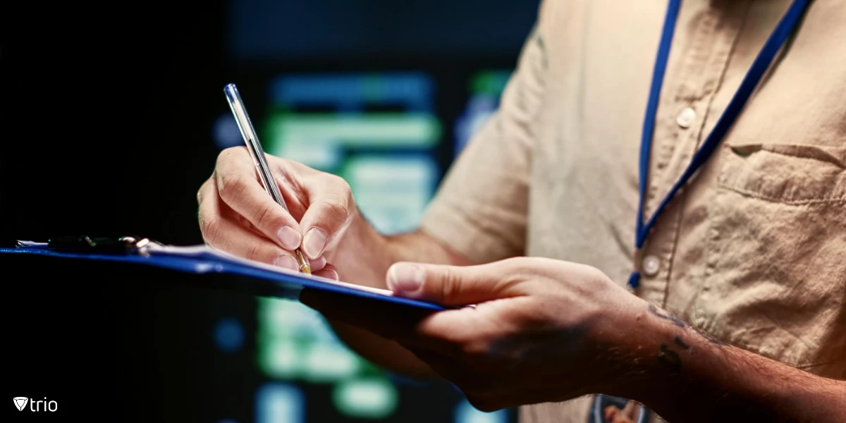 Man holding a pen ticking off an active directory security checklist