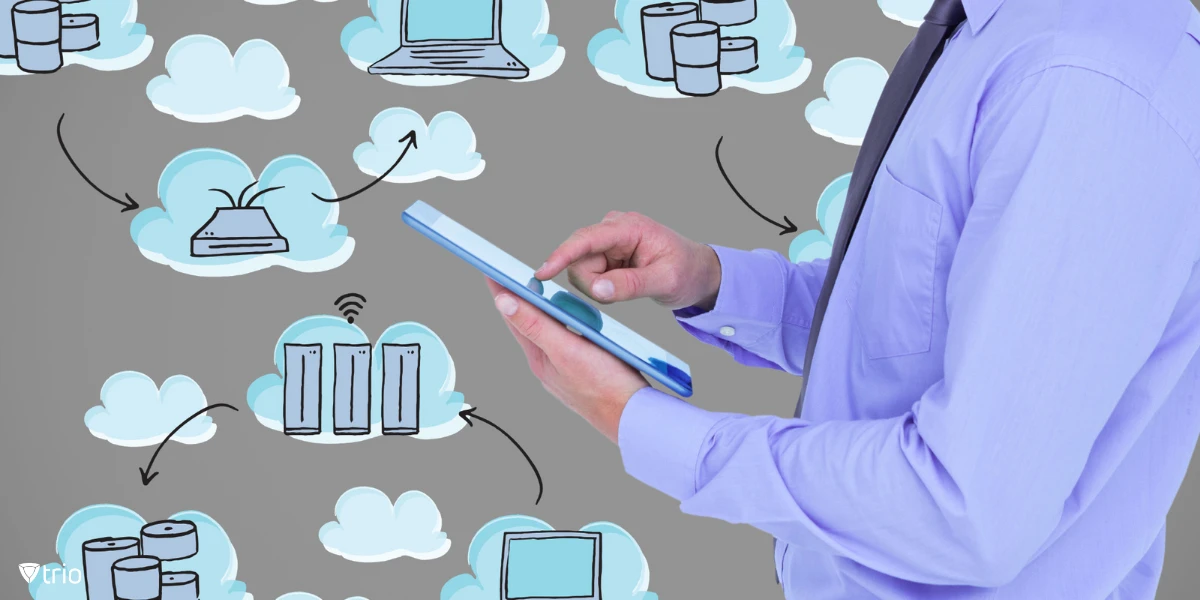 A person in business attire holding and interacting with a tablet, with the background filled with cloud icons and arrows