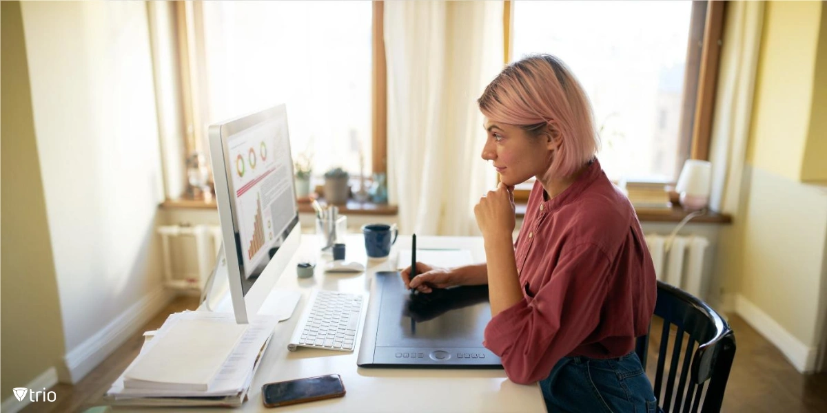 businesswoman working remotely with a pc in front of her displaying stats