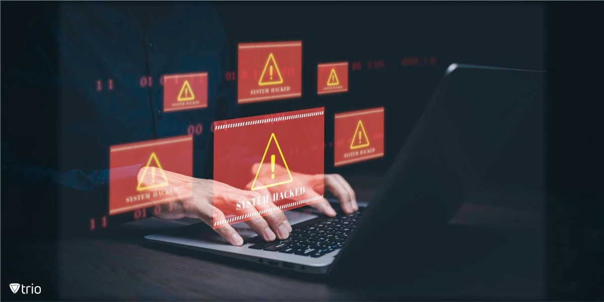 man working on a laptop with concept of hacked system with alert triangle popping up out of the screen