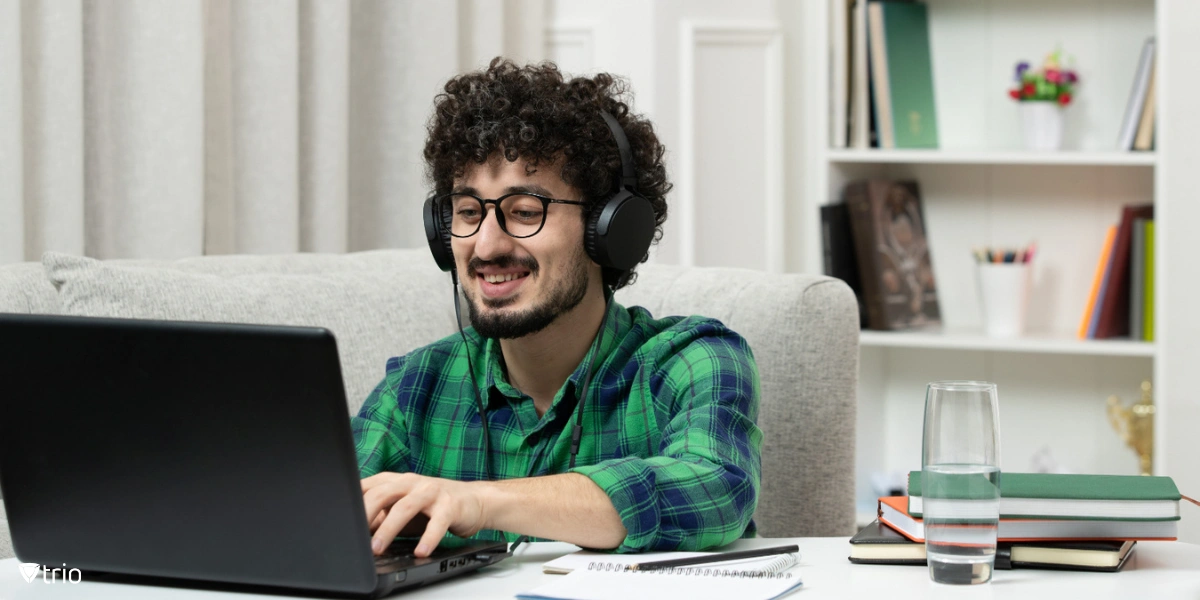 man using a laptop with a headset on his head