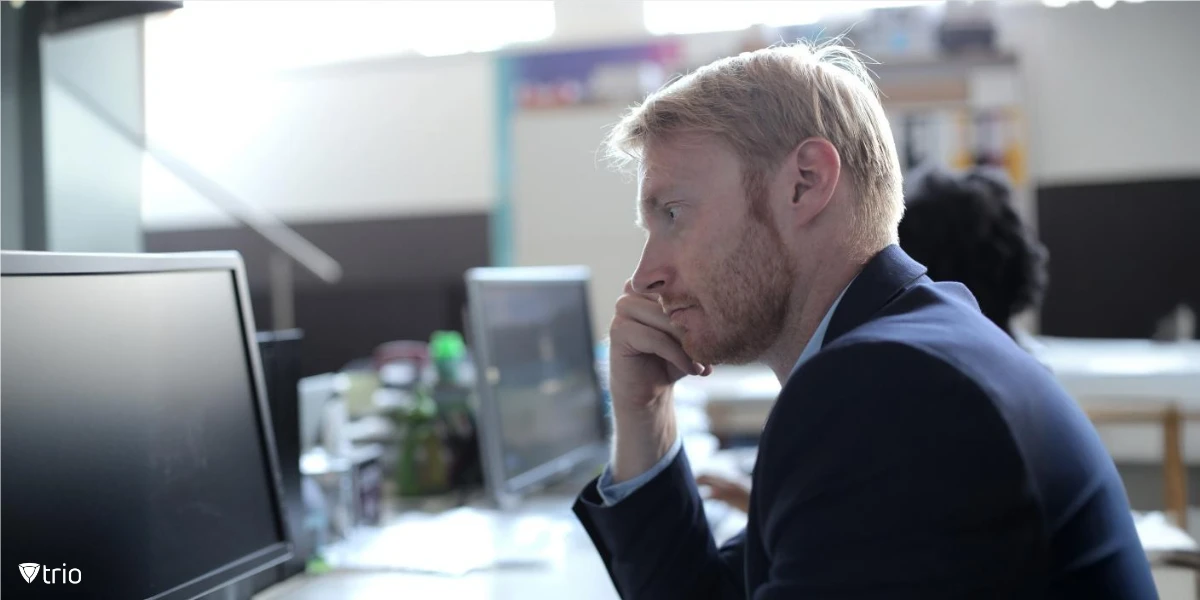 A focused businessman working on a computer in a contemporary office setting