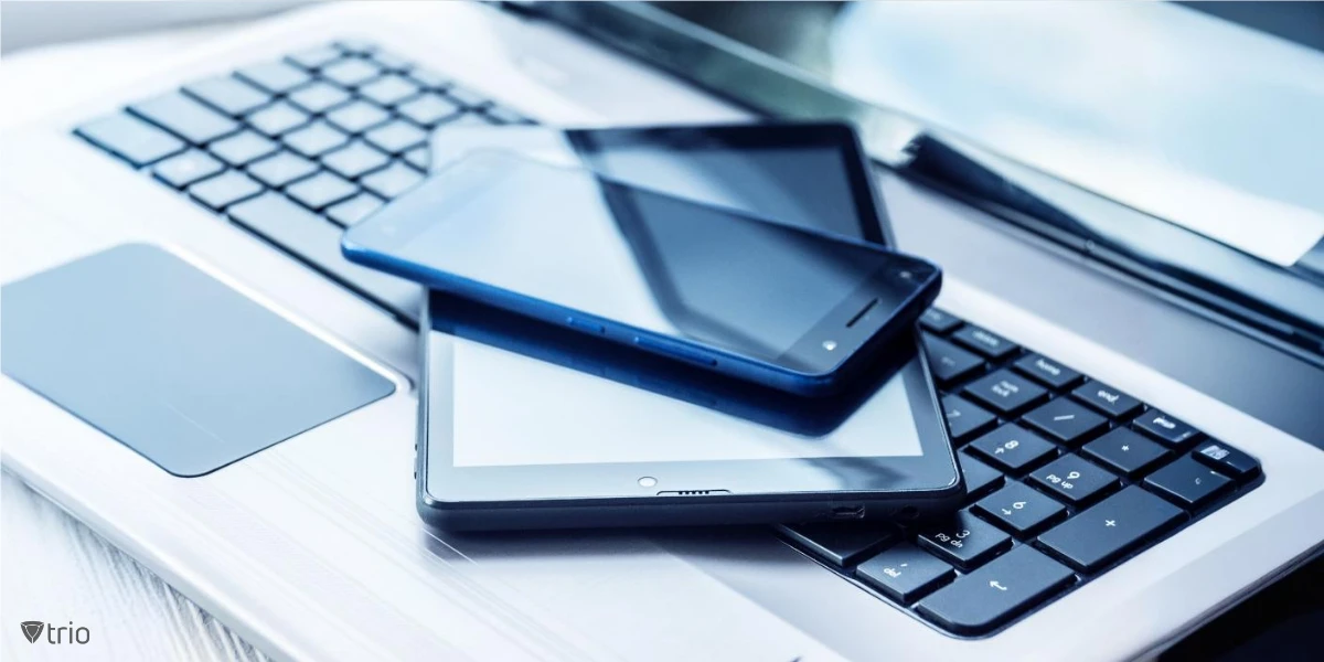 A laptop with a tablet and smartphone stacked on top