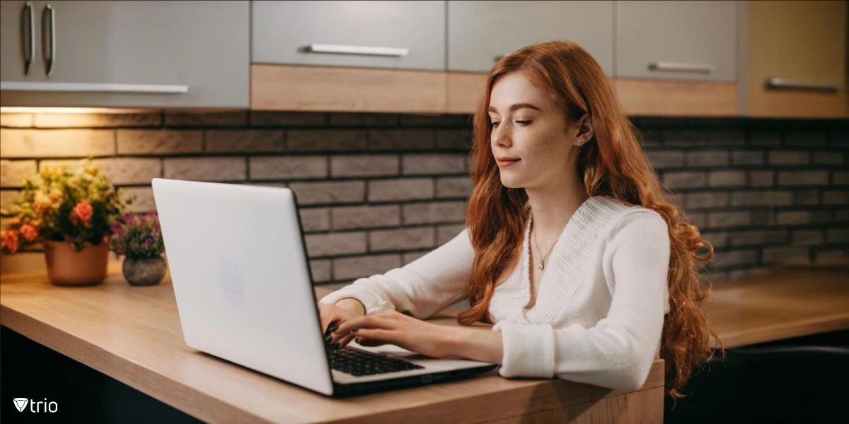 businesswoman sitting at a desk and working on a laptop