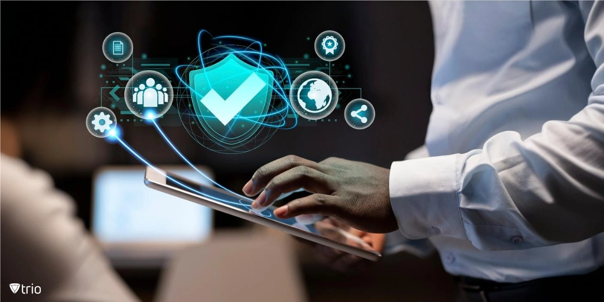 Close-up of hands working on a tablet, with icons representing safety, employees, documents, sharing, and a globe emerging from the screen.