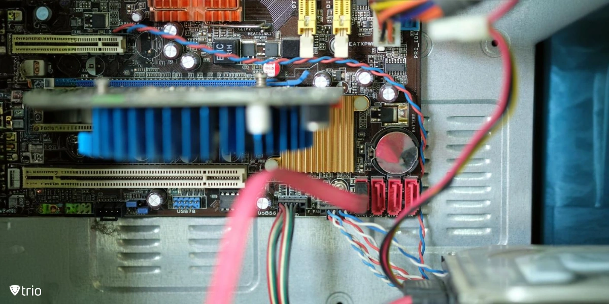 A close-up view of a computer's internal components, highlighting a circuit board with various connections, capacitors, and heat sinks