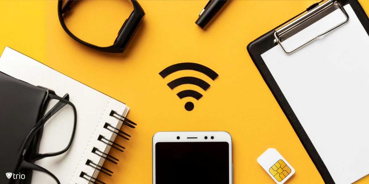 A flat lay on a yellow background showcases a smartphone, a SIM card, glasses, a smartwatch, and a clipboard surrounding a Wi-Fi symbol.