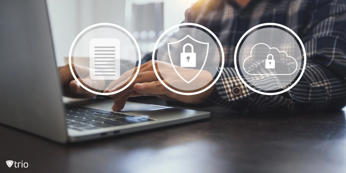 A person wearing a checkered shirt working on a laptop, with digital security icons (a document, a shield, and a cloud, all with padlock symbols) overlaid on the image.